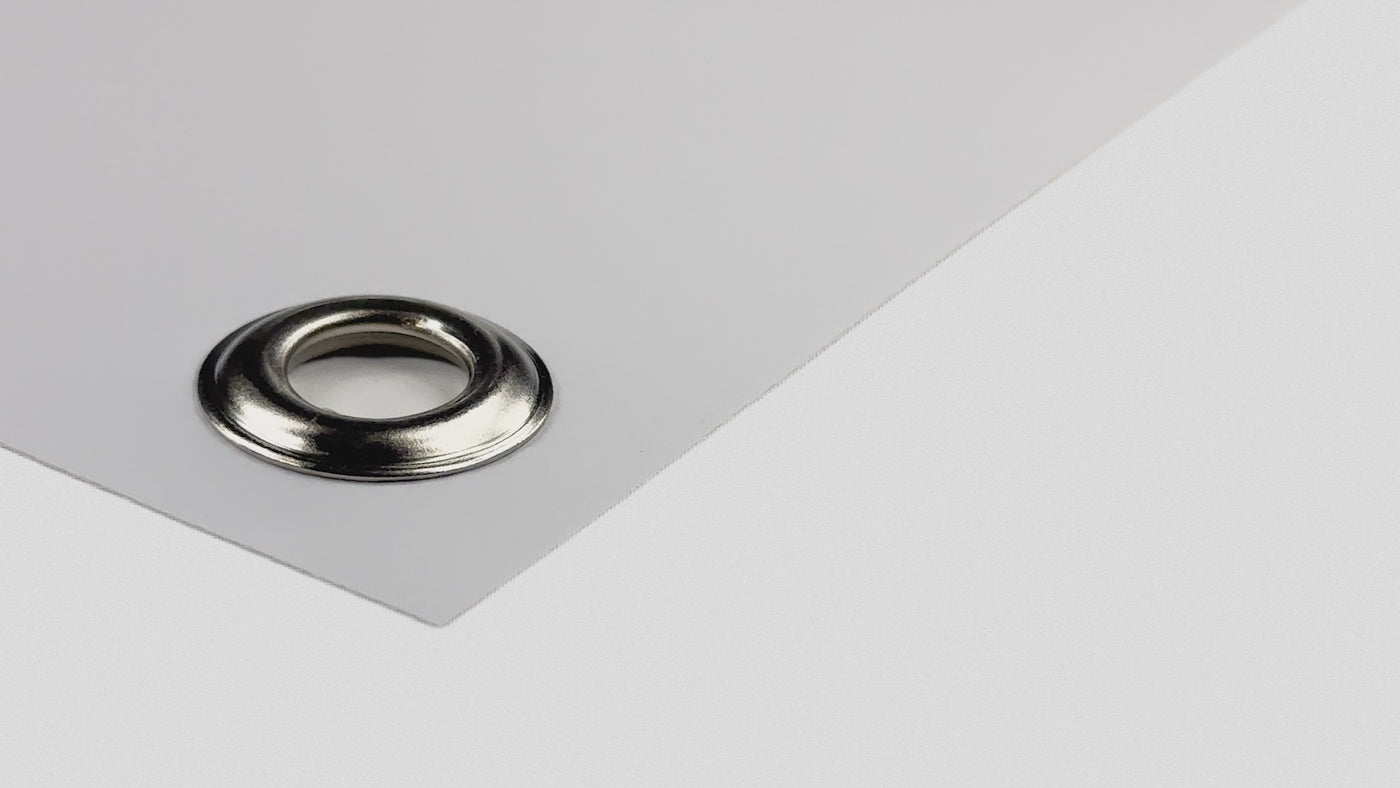 White PVC banner corner with a metal grommet eyelet